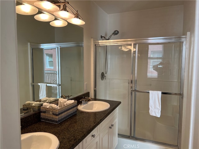 bathroom with vanity and a shower with shower door