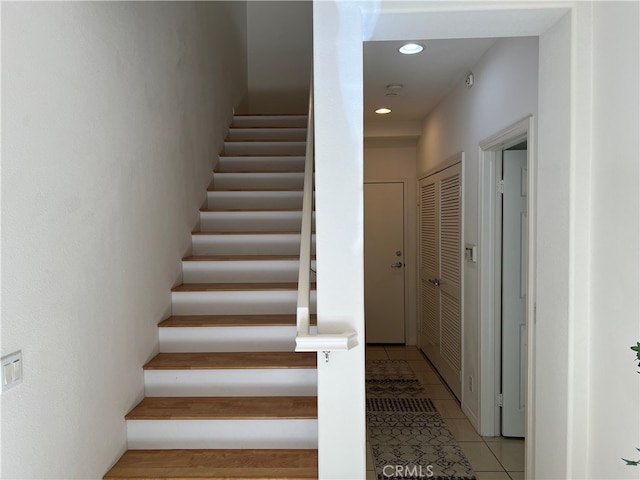 stairs featuring tile patterned flooring