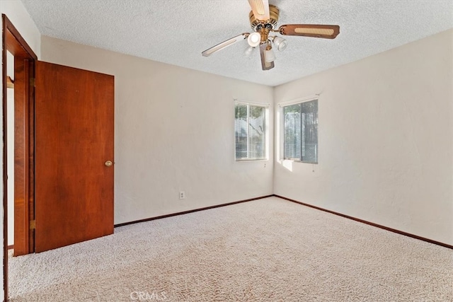 unfurnished bedroom featuring a textured ceiling, ceiling fan, and carpet floors