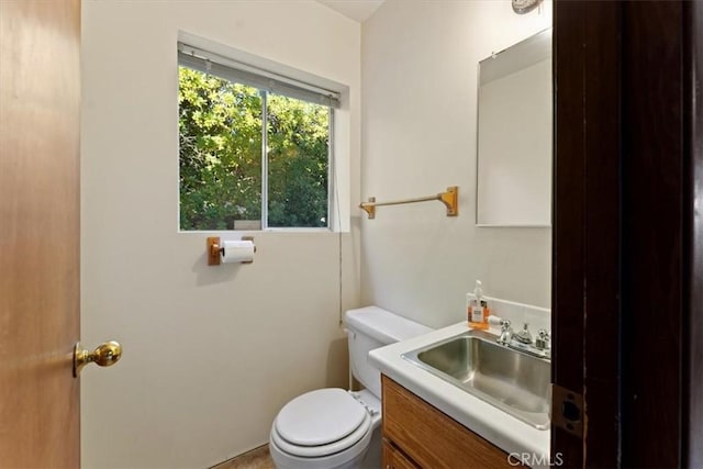 half bathroom featuring toilet and vanity