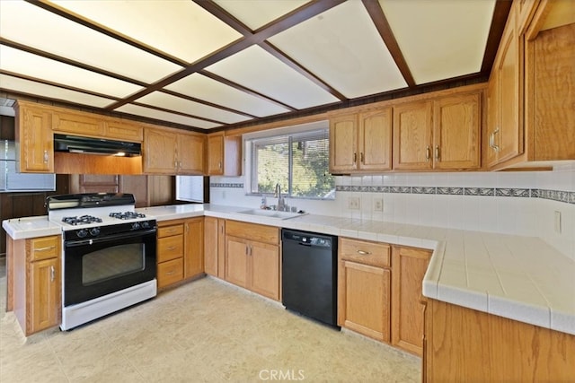 kitchen featuring sink, white range with gas stovetop, tile countertops, black dishwasher, and decorative backsplash