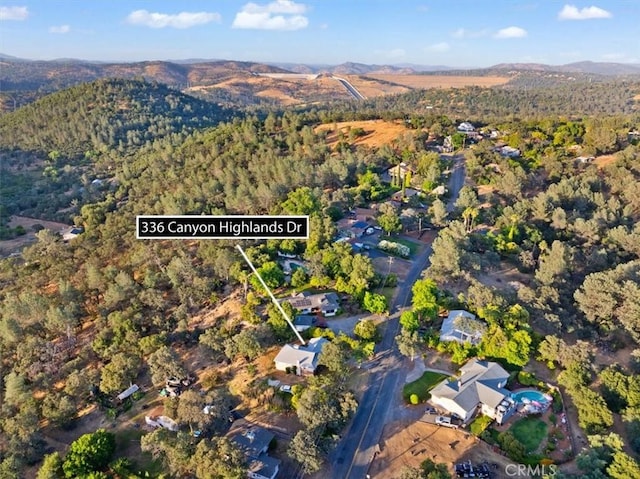 aerial view with a mountain view and a view of trees