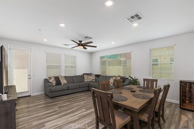 dining room featuring hardwood / wood-style floors, ceiling fan, and a healthy amount of sunlight