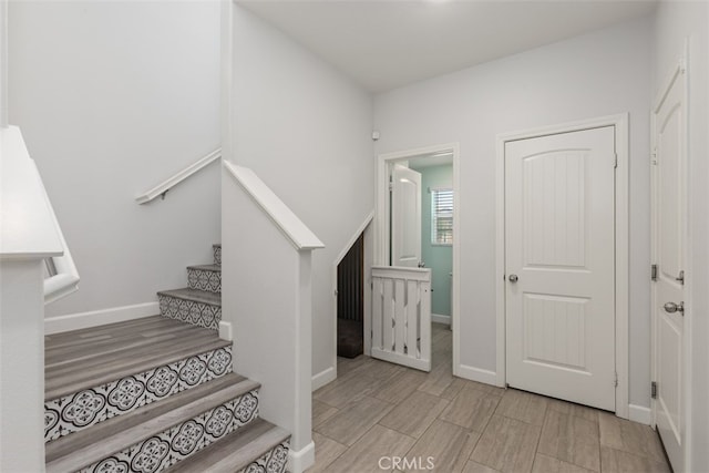 staircase with hardwood / wood-style flooring