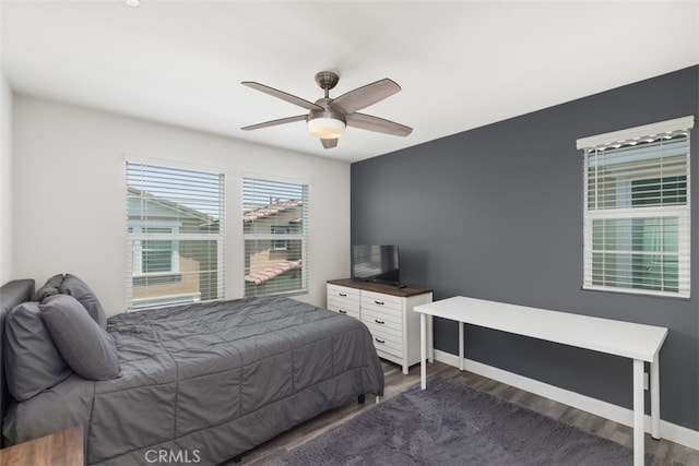 bedroom featuring ceiling fan and dark hardwood / wood-style flooring