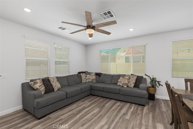 living room featuring hardwood / wood-style floors and ceiling fan