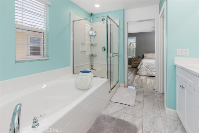 bathroom featuring a wealth of natural light, vanity, and independent shower and bath