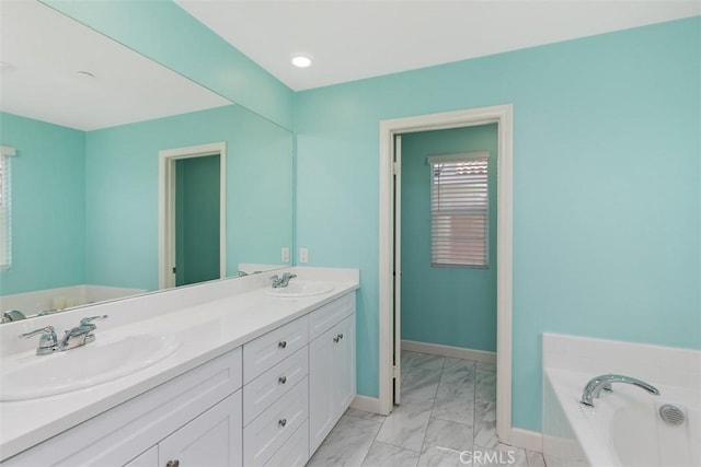 bathroom with vanity and a bath