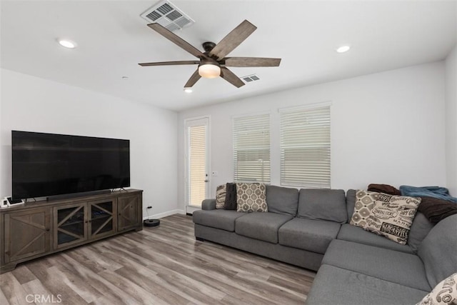 living room featuring hardwood / wood-style flooring and ceiling fan