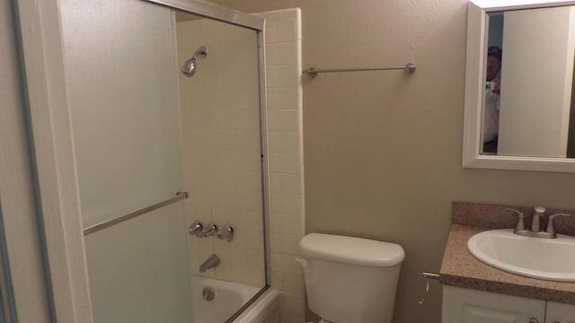 full bathroom featuring vanity, toilet, and enclosed tub / shower combo