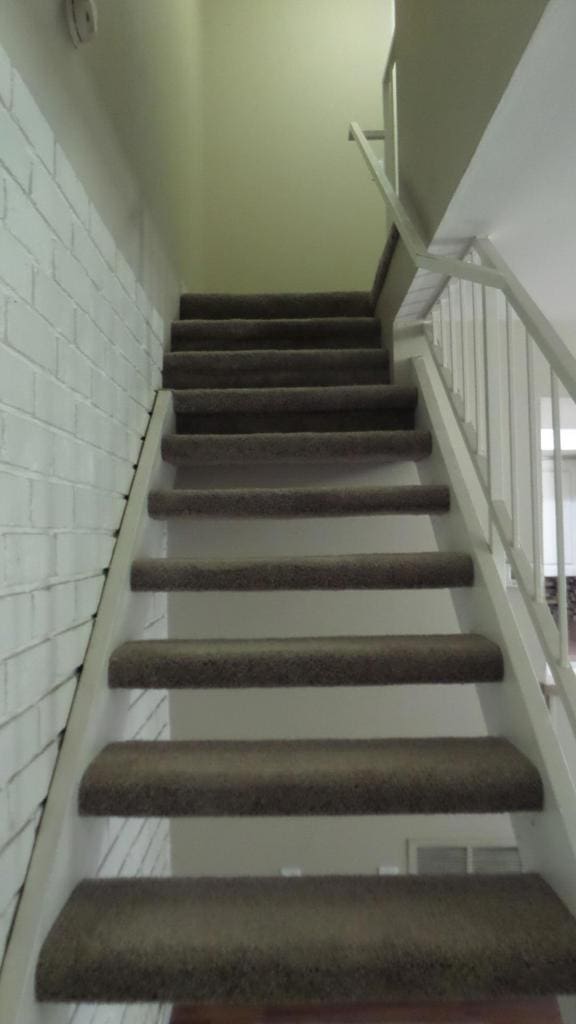 stairway with brick wall