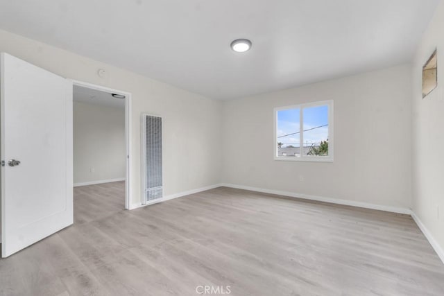 unfurnished room with light hardwood / wood-style floors