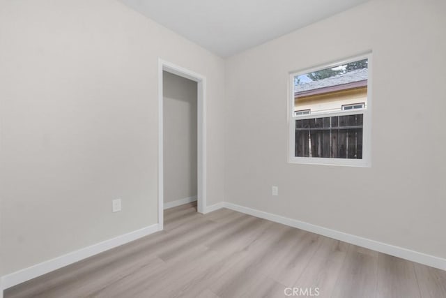 spare room with light wood-type flooring