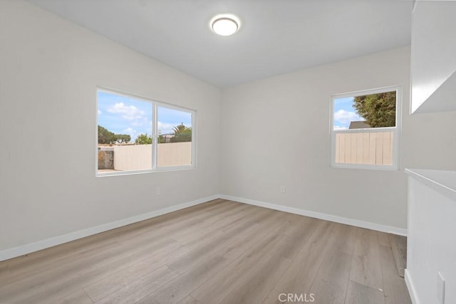 empty room featuring light hardwood / wood-style floors and a wealth of natural light