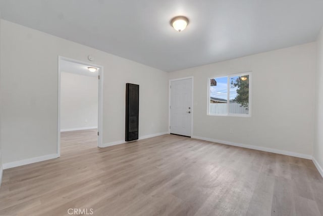 unfurnished room with light hardwood / wood-style flooring