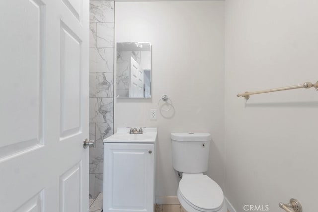 bathroom with tile patterned floors, vanity, and toilet