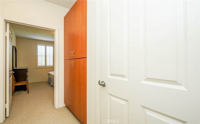 corridor featuring light colored carpet