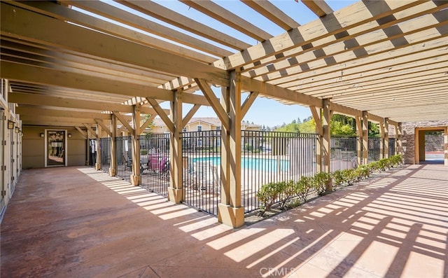 view of patio featuring a community pool and a pergola