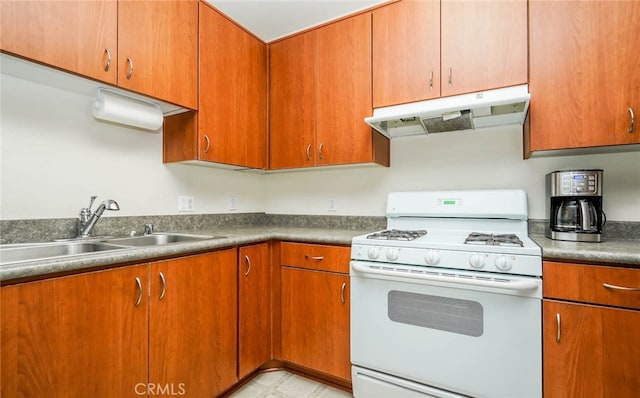 kitchen featuring white gas stove and sink