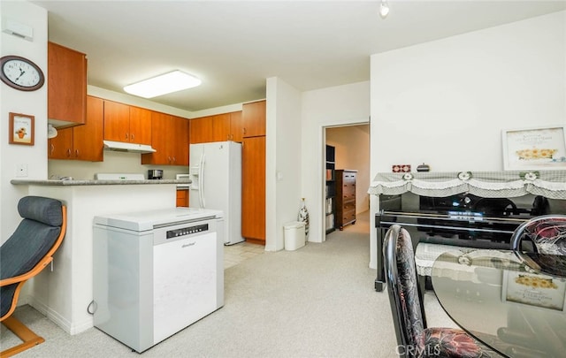 kitchen with white fridge with ice dispenser, kitchen peninsula, light carpet, and refrigerator