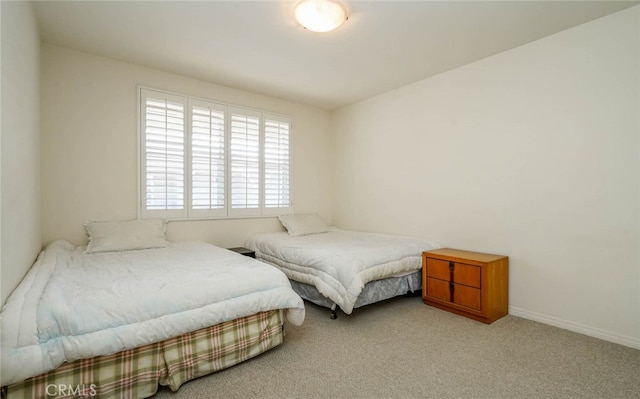 bedroom with light colored carpet