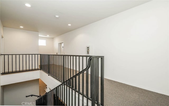 stairway featuring carpet flooring