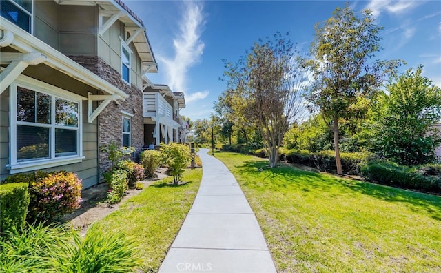 view of yard with a balcony