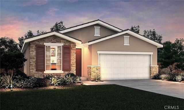 view of front facade with a garage and a yard