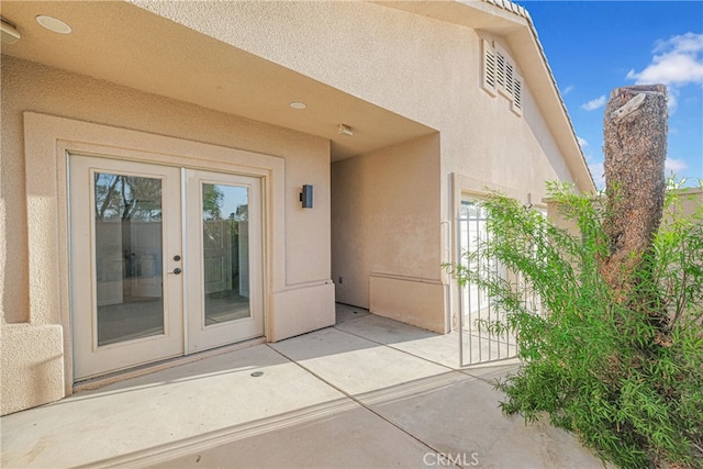 entrance to property featuring french doors and a patio area