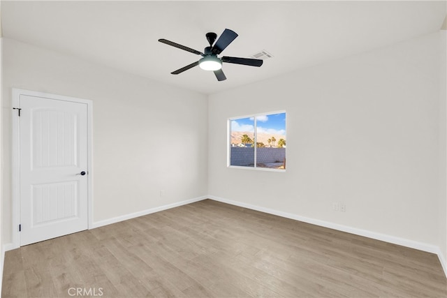 empty room featuring ceiling fan and light hardwood / wood-style flooring