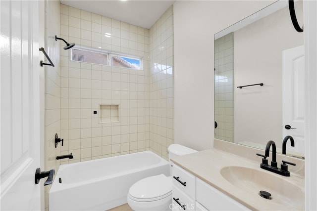 full bathroom with vanity, toilet, and tiled shower / bath