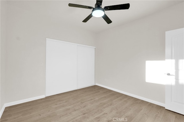 interior space featuring light wood-type flooring, a closet, and ceiling fan