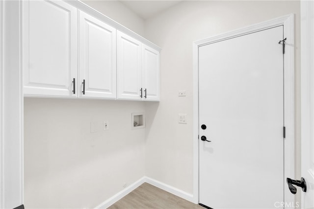 laundry room featuring washer hookup, cabinets, and light wood-type flooring