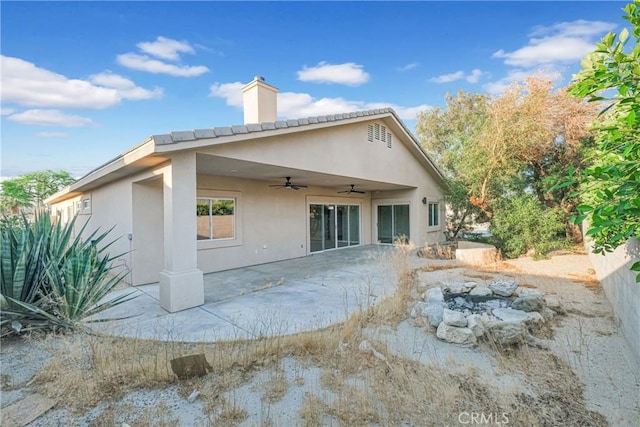 back of house with ceiling fan and a patio