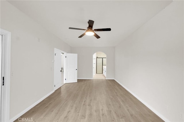 empty room featuring ceiling fan and light hardwood / wood-style flooring