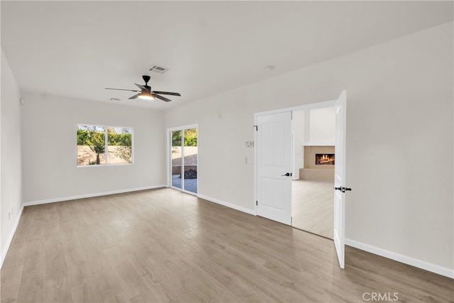 unfurnished room featuring light hardwood / wood-style flooring and ceiling fan