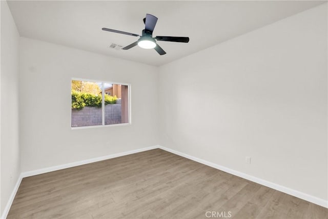 empty room featuring hardwood / wood-style floors and ceiling fan