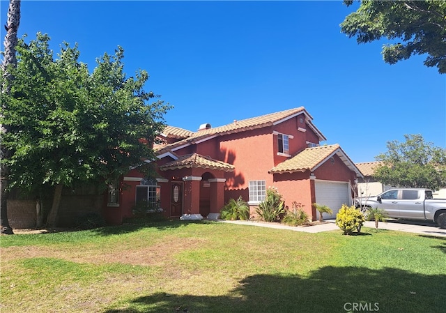 view of front of home featuring a front yard and a garage