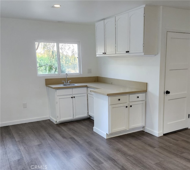 kitchen featuring white cabinetry, dark hardwood / wood-style flooring, and sink