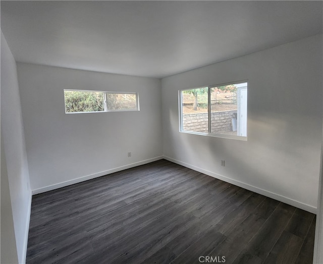 unfurnished room featuring dark wood-type flooring