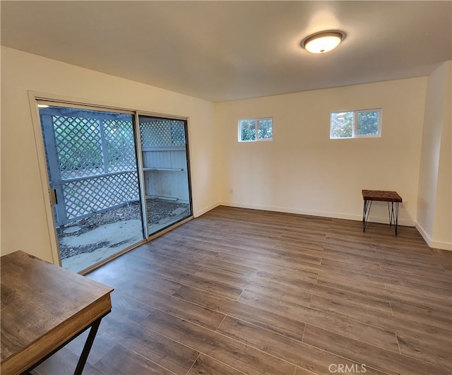 unfurnished room with dark hardwood / wood-style flooring