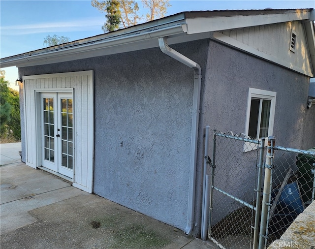 view of side of property featuring french doors