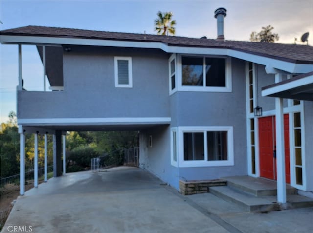 view of front of property featuring a carport