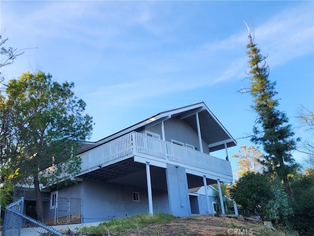 view of property exterior featuring a wooden deck