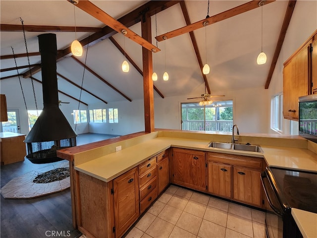 kitchen featuring black appliances, sink, kitchen peninsula, ceiling fan, and pendant lighting