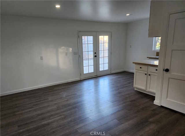 unfurnished dining area with french doors and dark hardwood / wood-style floors