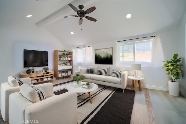 living room featuring ceiling fan, light hardwood / wood-style flooring, and vaulted ceiling