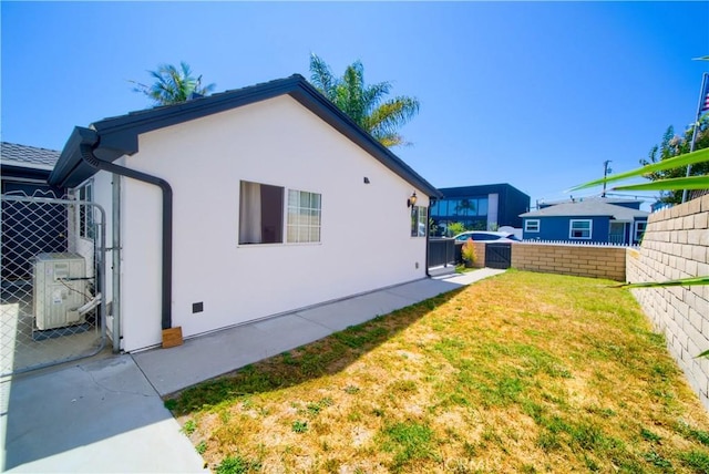 view of home's exterior with a yard and ac unit