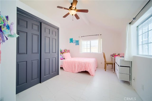 bedroom with multiple windows, ceiling fan, and a closet