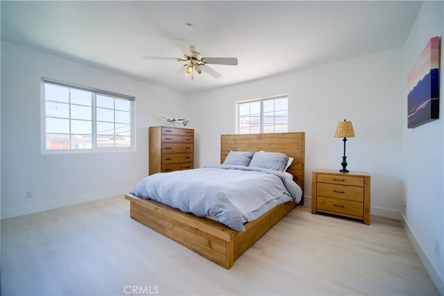 bedroom featuring light wood-type flooring and ceiling fan